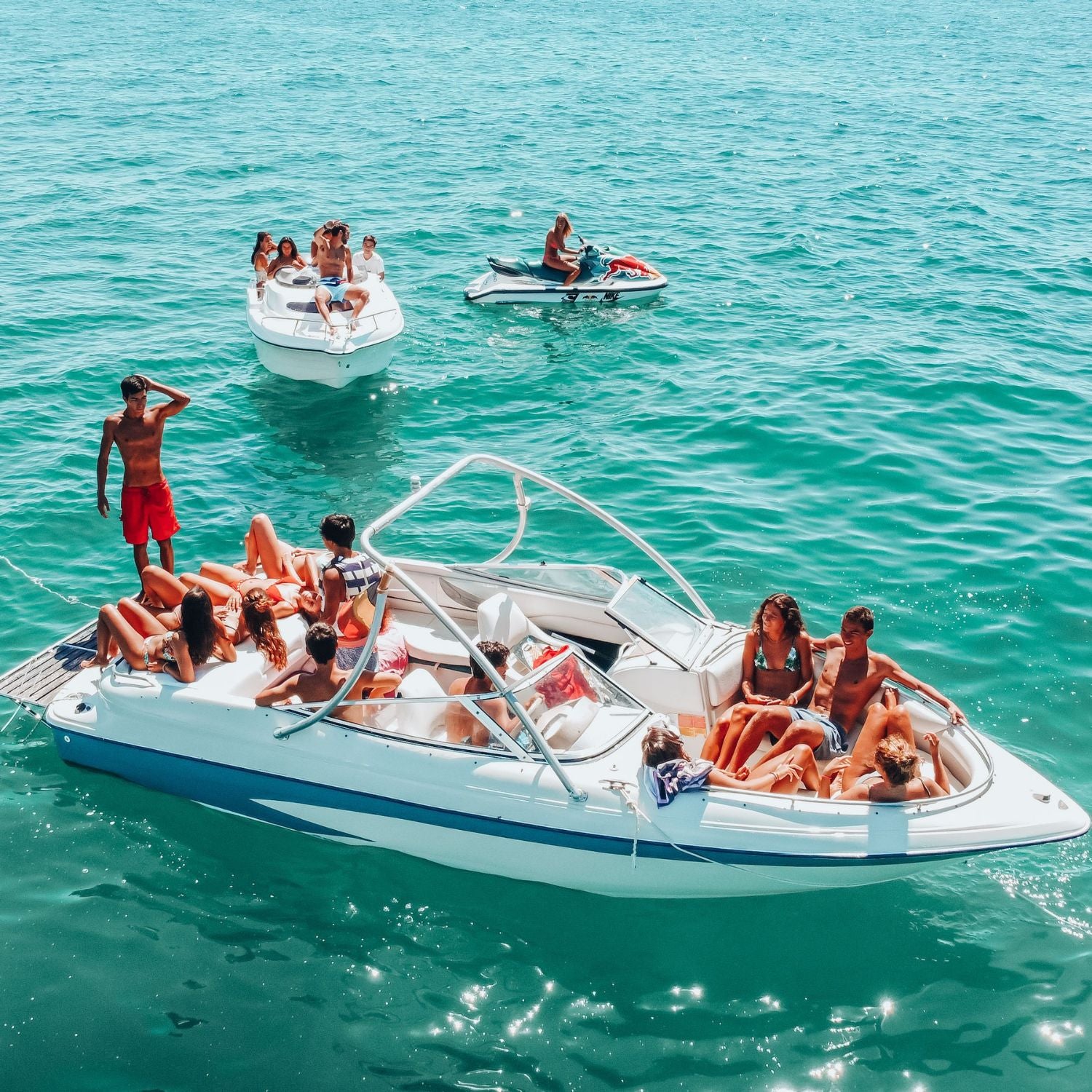 Group of people enjoying a boat ride on a clear blue sea
